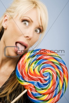 Woman licking a lollipop