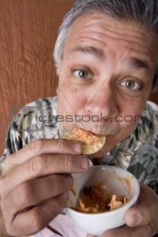 Man Eating Chips and Dip