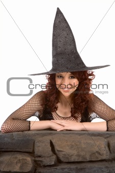 Smiling read head teen girl in Halloween hat