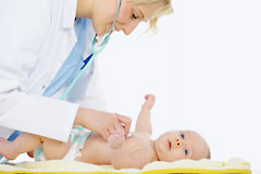 Doctor checking baby with stethoscope